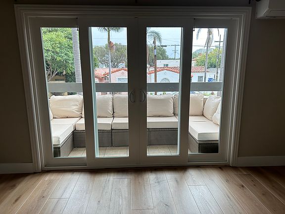 French doors leading to balcony. Outdoor couch and cushions are included with the condo.