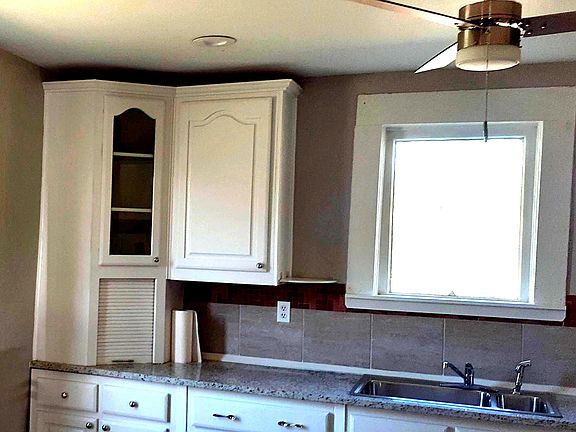 Kitchen with ceing fan and corner cabinet