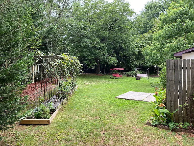 The yard is surrounded by plenty of flowers & plants, a vineyard trellis, and a box area for growing cooking herbs. If you wish, there is space for your own veggie and flower garden! Lawn maintenance included.