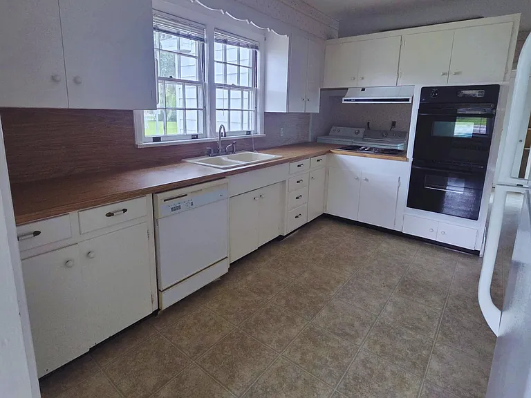 Large kitchen featuring abundant cabinets and a bright, inviting design.