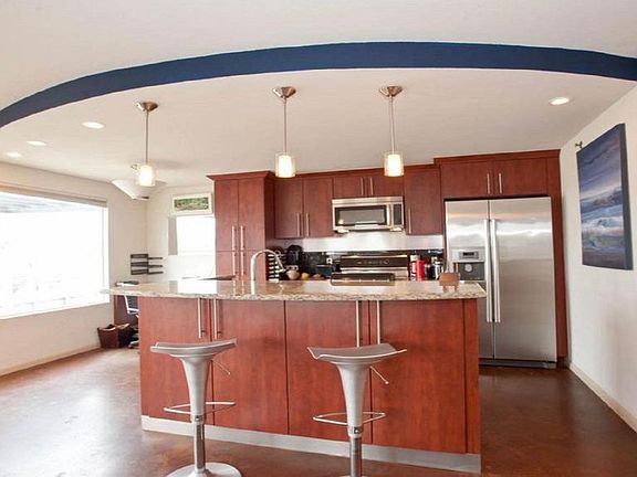Counter with two bar stools. Built-in desk in corner.