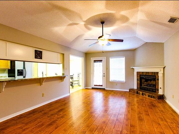 Fireplace, vaulted ceiling, & beautiful wood floors.