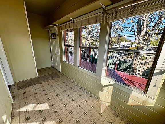 Enclosed Sun Room Photo #2 Showing Entrance out to Elevated Redwood Deck and Stairs Down to Ground Level