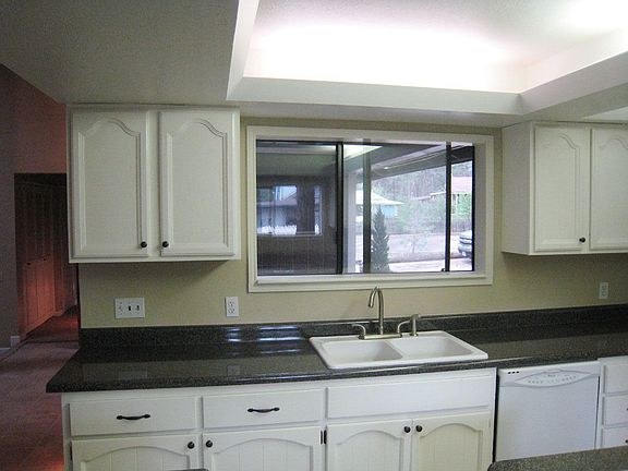 Kitchen has new countertops and a new gas stove. 