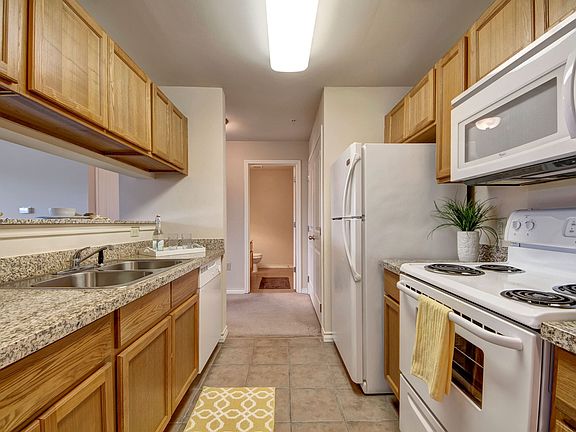 Galley style kitchen with granite countertops and a breakfast bar