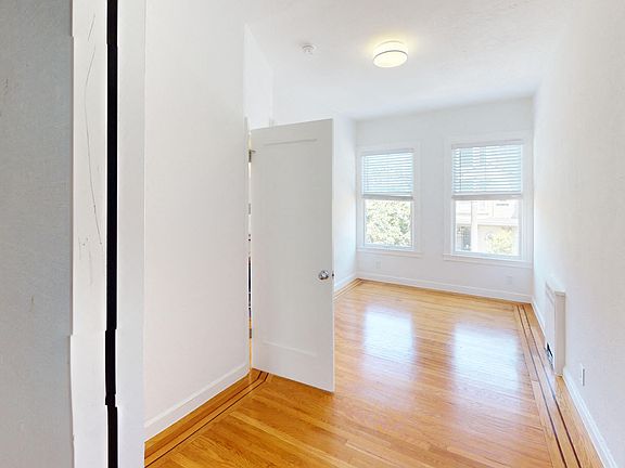 Sunlit room with a wood-like flooring and large window