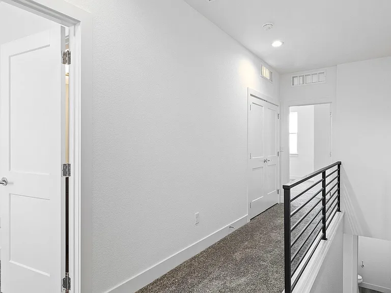 Upstairs Hallway leading to Laundry Room & Primary Suite