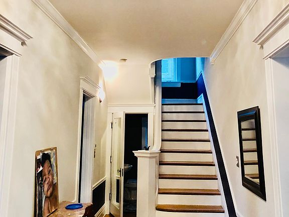 Front entry foyer facing west with half bath door open
