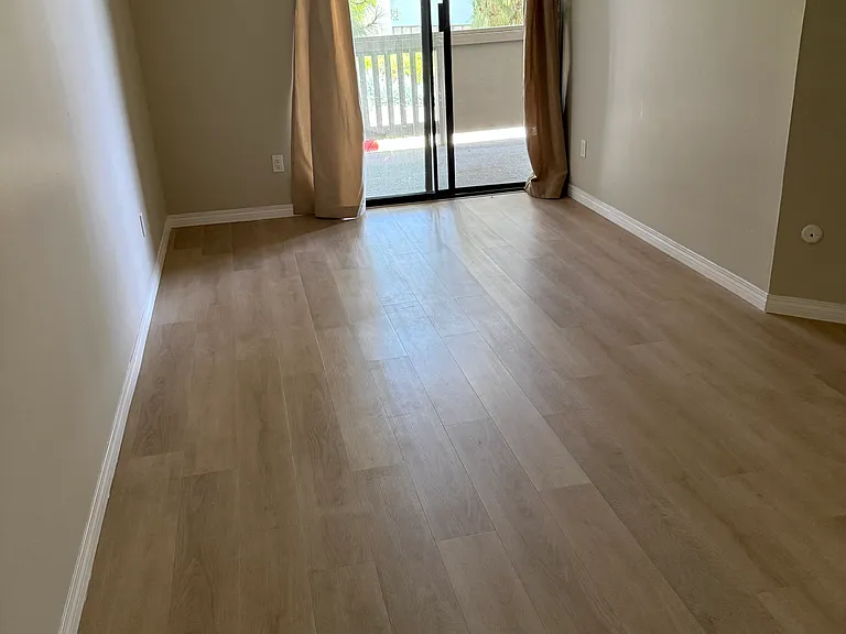 Spacious master bedroom with ample space for an office area or child's bed.