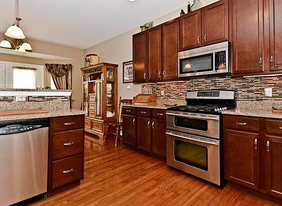 all stainless upgraded appliances that include a double oven, microwave, dishwasher, refrigerator. G
