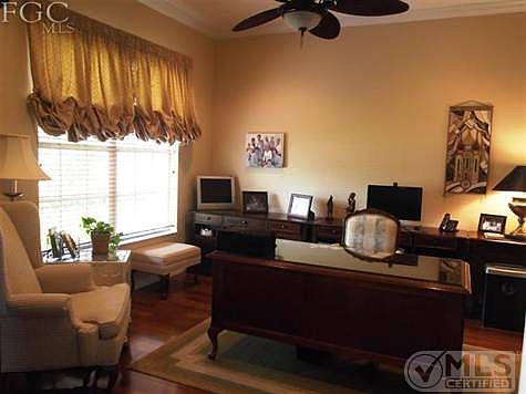 The den is located to the left of the foyer. It has Braziian wood laminate floors, & crown molding. Beautiful
