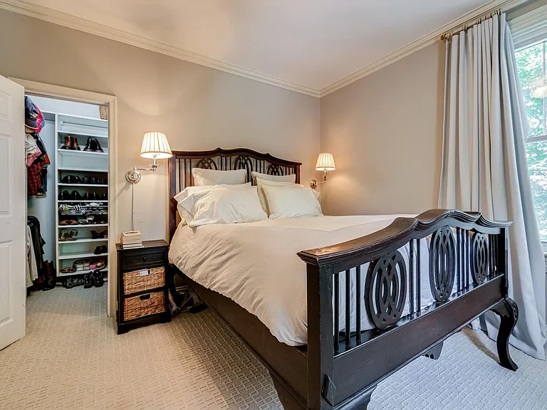 Master bedroom with walk-in closet and two built-in armoires.