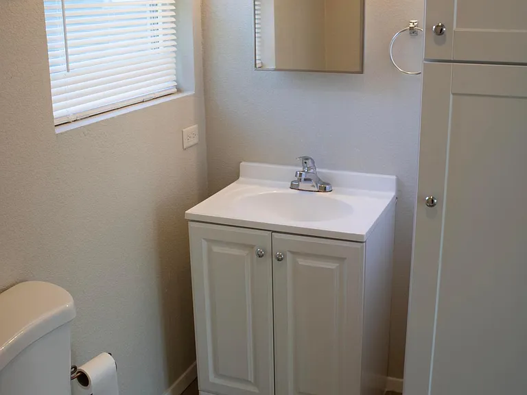 Bathroom with vanity and linen closet