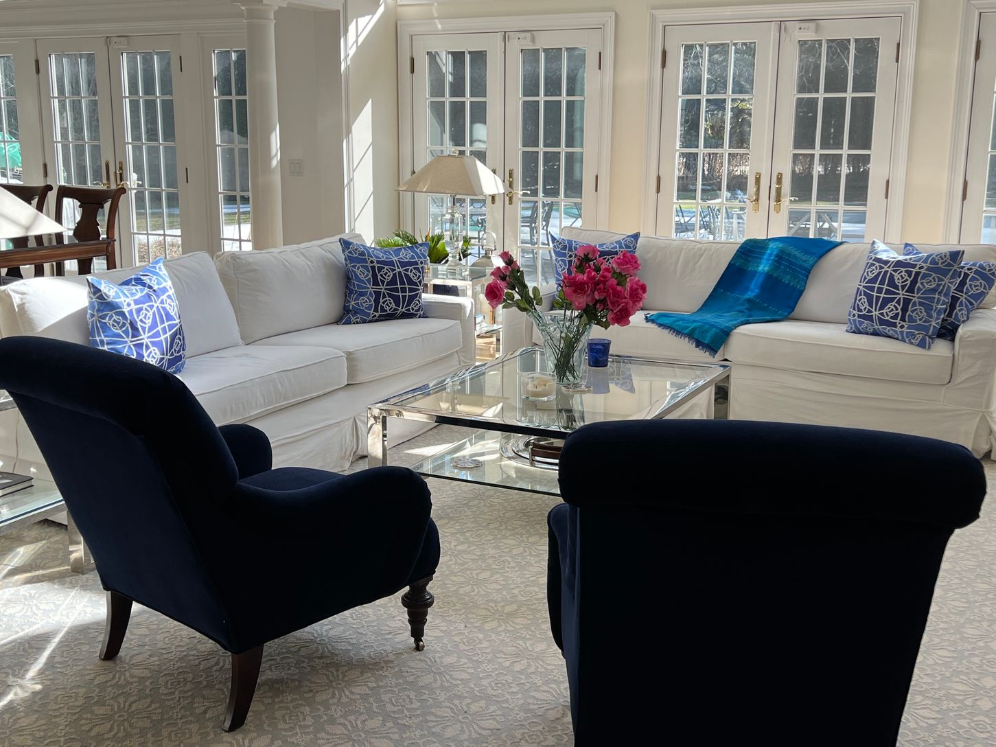  Mitchel Gold slipcovered white sofas; double height, sun-filled living room.