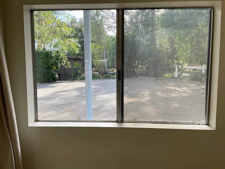 Den window to rear driveway