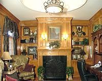Main level paneled study with fireplace and custom built-ins.