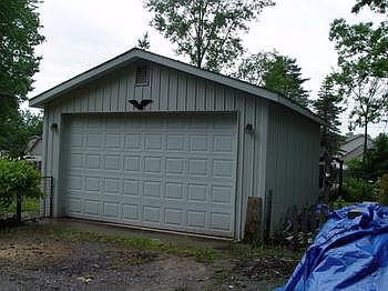 Large garage with electric and cement floor for toys storage.