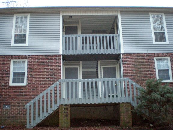 Back of Building. Apt. E is on the left downstairs. There are 6 steps up from the parking lot to the entrance deck.