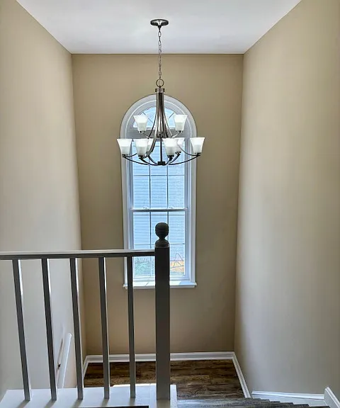 Landing and large arched window.