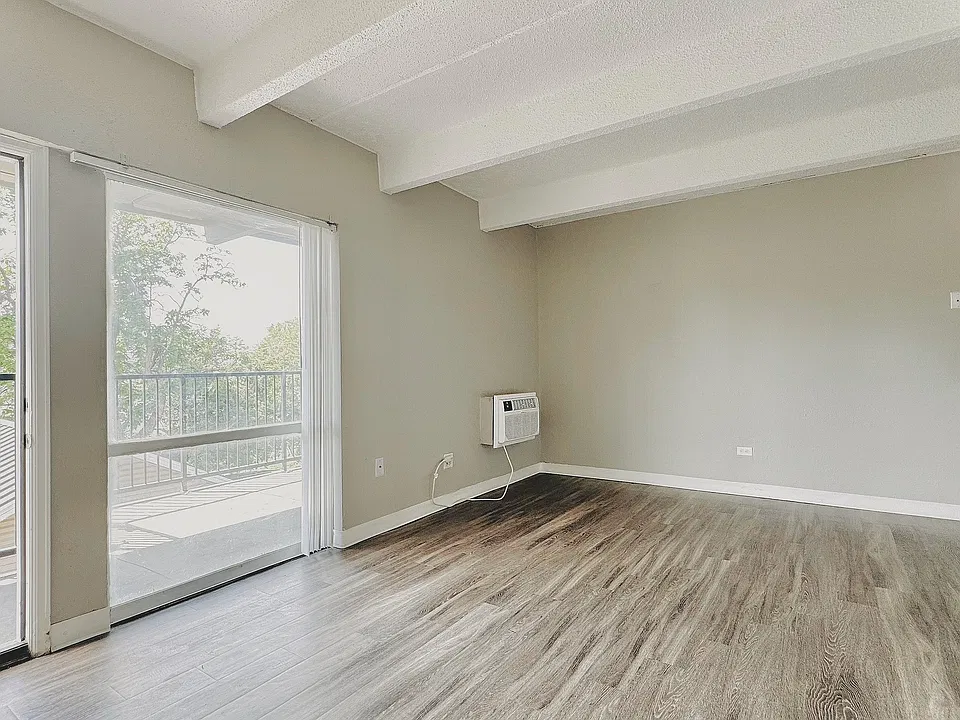 Bright and modern living room featuring stylish plank flooring, fresh two-tone paint, and an open-concept layout_perfect for relaxing or entertaining