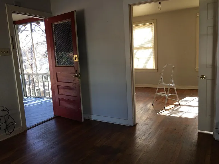 Living room to screened porch and front bedroom
