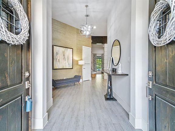 Entry features a custom wall paper treatment and upgraded light fixture.