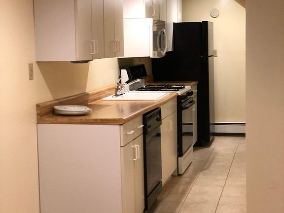 Galley Kitchen, tile floor, gas stove, dishwasher, microwave, new refrigerator