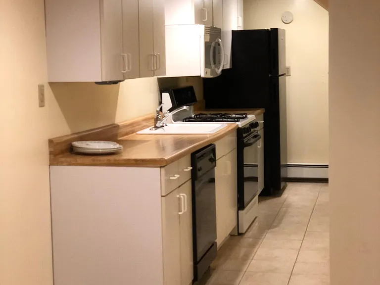 Galley Kitchen, tile floor, gas stove, dishwasher, microwave, new refrigerator