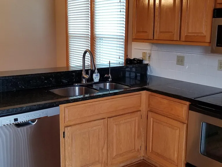 Kitchen - Marble Countertops, recently installed dishwasher and faucet. Also has a hook up for a recently installed water filtration system (to the right of the faucet).
