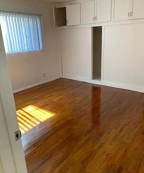Bedroom with large closet and storage cabinets.