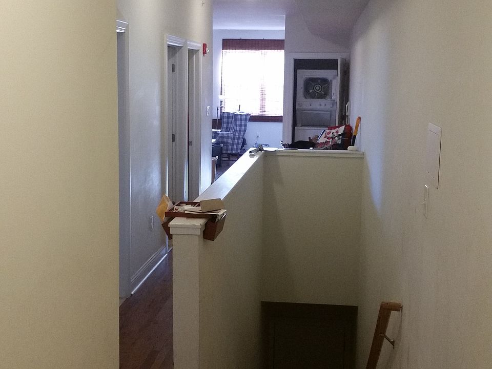 Long hallway connecting all rooms and bathrooms, washer/drye