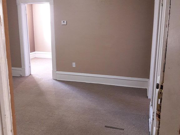From entry door. Closet to right. kitchen far wall right. Bedroom is open door across room