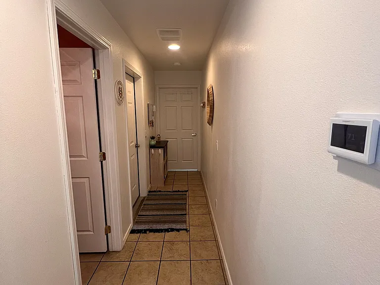 Hallway/"mud room" (first door on left is to half bath, second door to garage and third door to office/4th bedroom)
