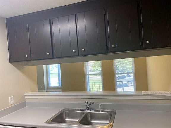 Upper cabinets in kitchen. View from kitchen thru the pass thru into the dining area