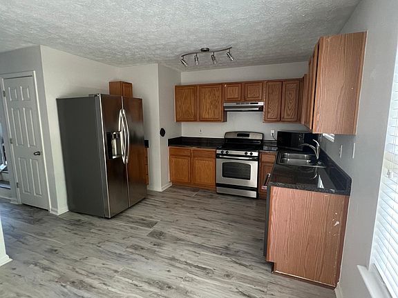 Spacious open kitchen with high end appliances (microwave, dishwasher, and 2-door fridge included)