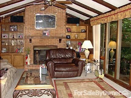 Living Room : Fireplace, floor to ceiling glass windows across front of room. Catheral ceiling