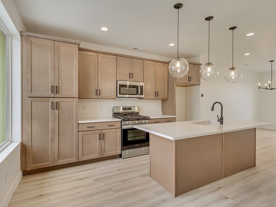 Kitchen with tan cabinets and center island in a sego home