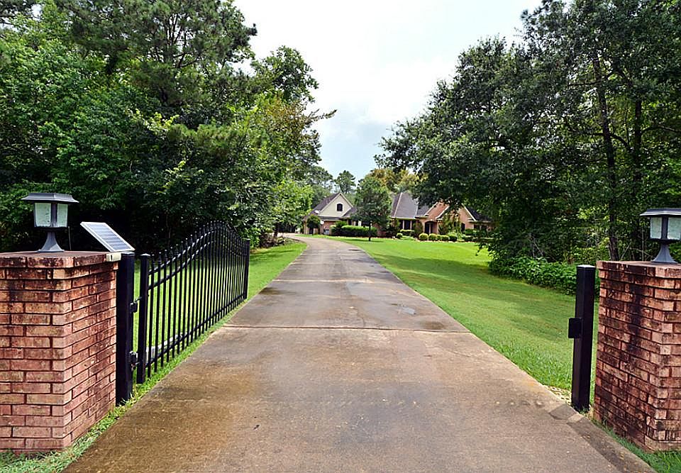Grand entrance to a gorgeous home! Pretty iron gate adds security and privacy to this executive home