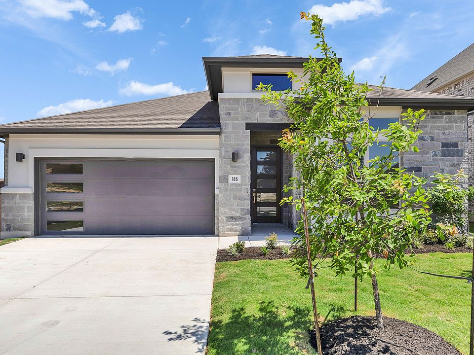 Texas home boasts sleek stone facade and spacious garage, offering refined suburban elegance.