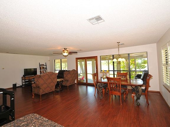 Dining room and living room.
						:
						Plantation shutters on the right. open the upstairs floor plan is.