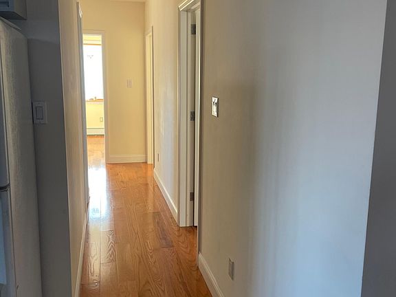Hallway past the kitchen leads to a bathroom on the left, two small bedrooms on the right, and one big bedroom at the end.