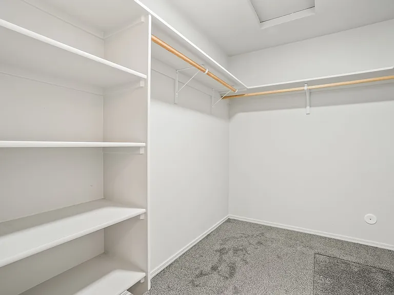 Primary walk in closet with built in storage