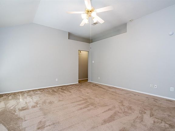 A spacious family room for all to gather and enjoy a night at home with soft carpet under foot! A decorative ledge provides a place to put houseplants, or treasured mementos!