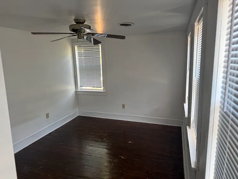 Second floor first bedroom with ceiling fan (front of house) with access to walk up small attic that can be used for storage