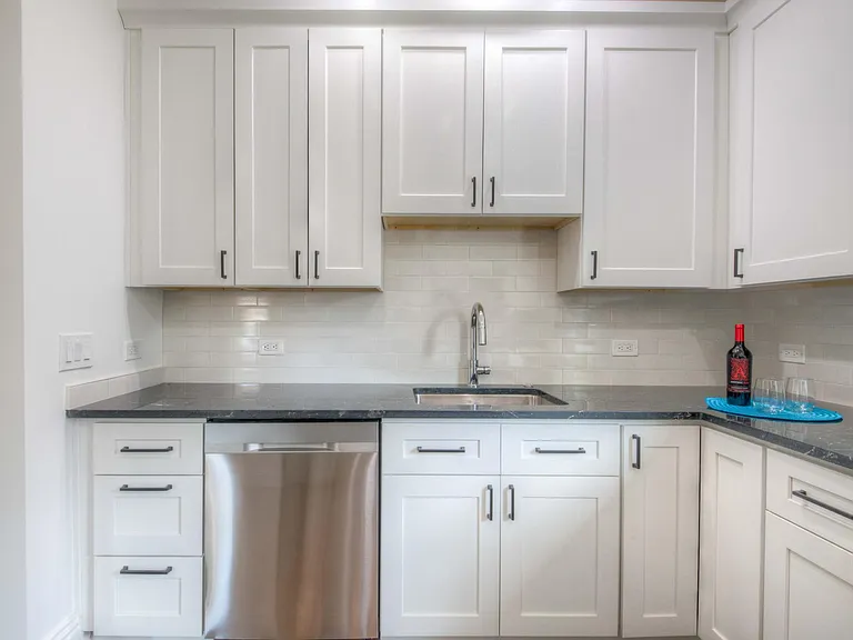 Kitchen showing dishwasher and sink side