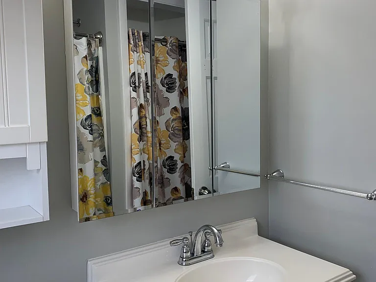 1st floor bathroom
large mirrored medicine cabinet
storage cabinet above toilet