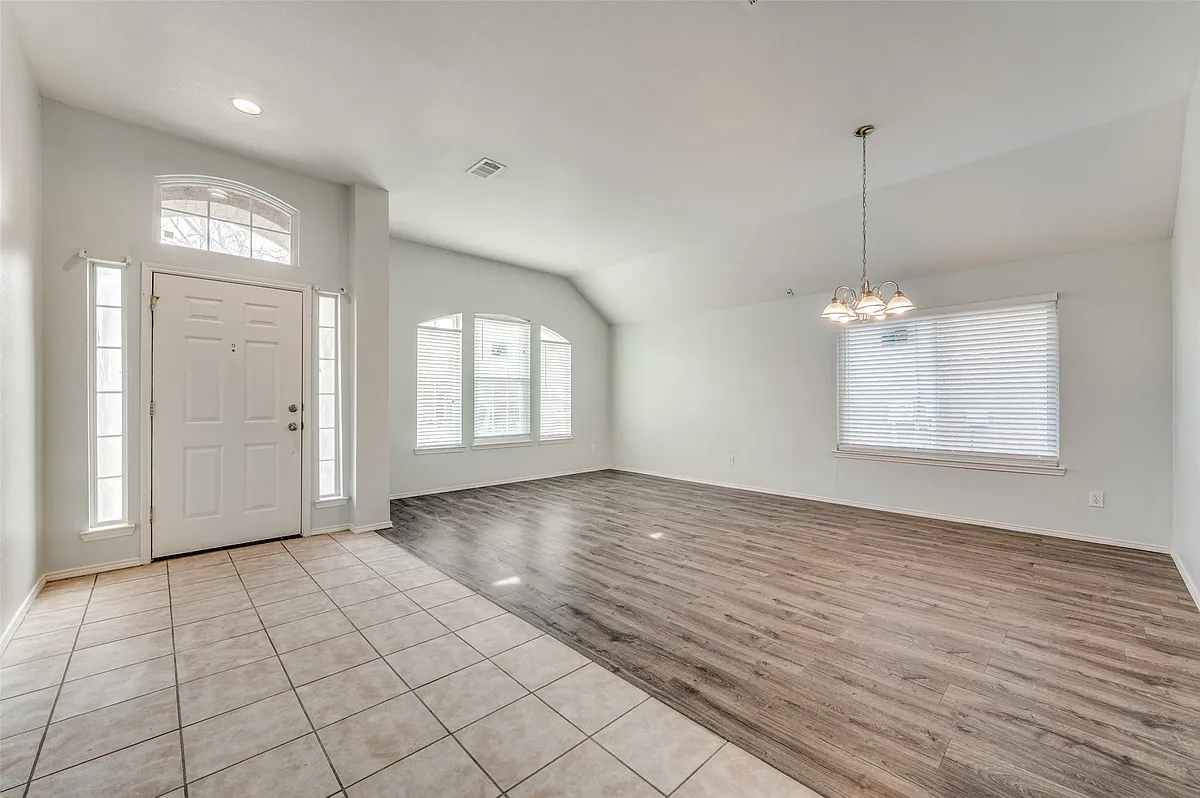 Foyer entrance featuring a white paneled door with sidelights and an arched transom window - 5828 Shetland Cir