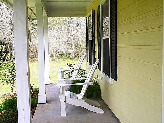 This is a true front porch and is the length of the home. The cover makes it a great place to sit un