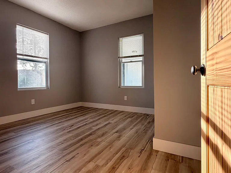 Spacious first-floor bedroom 2/6 _ perfect for guests or home office. Barrier-free main level living.