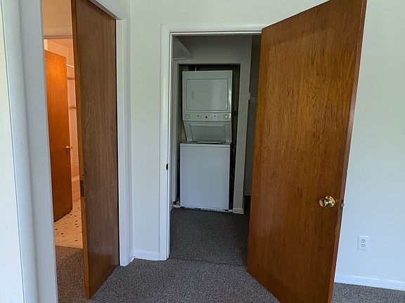 Washer/dryer and pocket door to hallway.